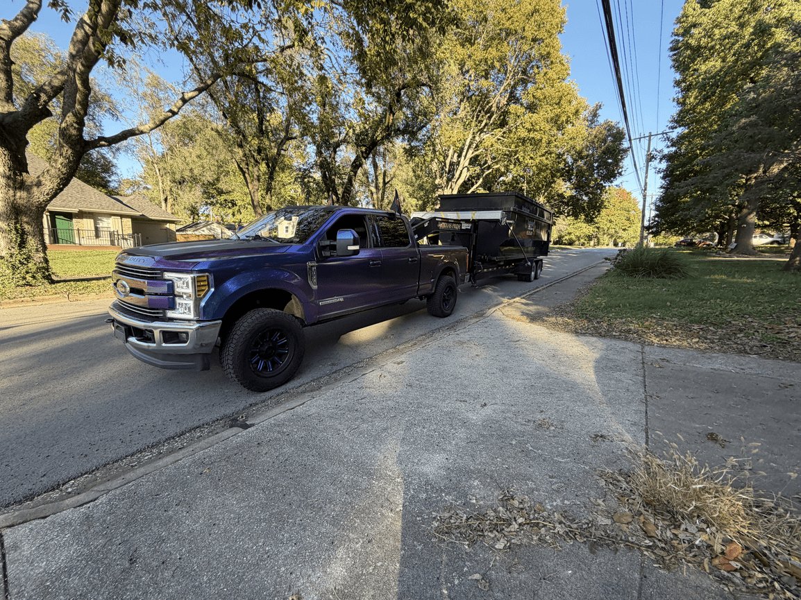 Diamond Dumpsters & Dirtworks truck delivering a dumpster