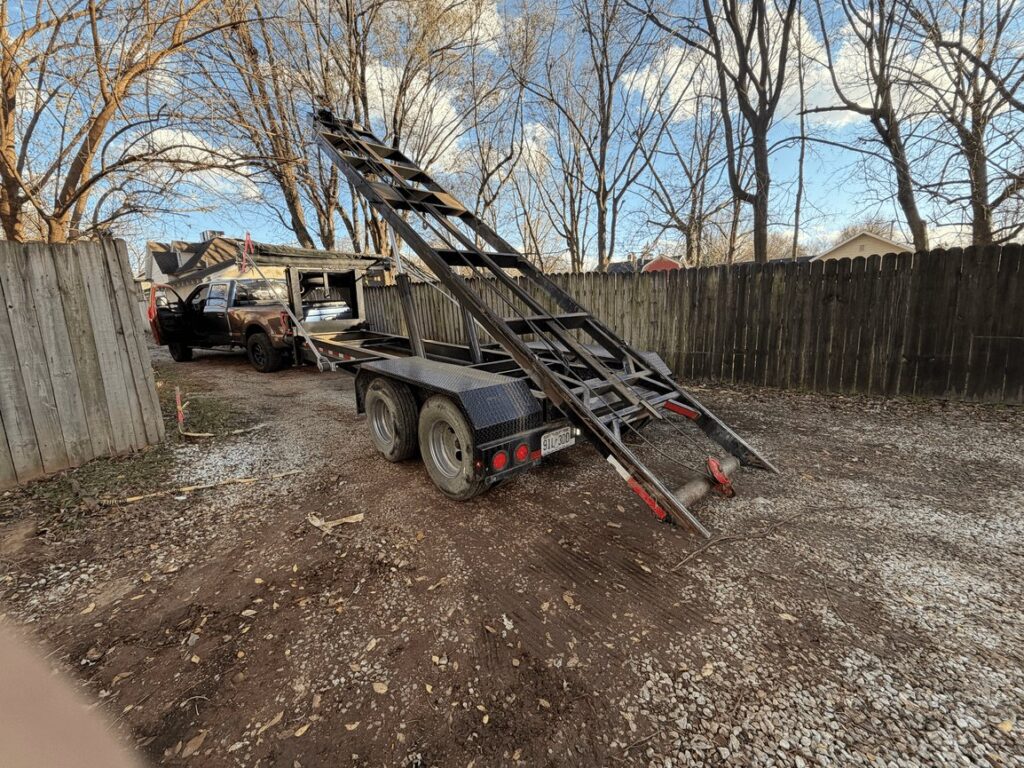 Roll-off dumpster trailer on a job site in the Ozarks