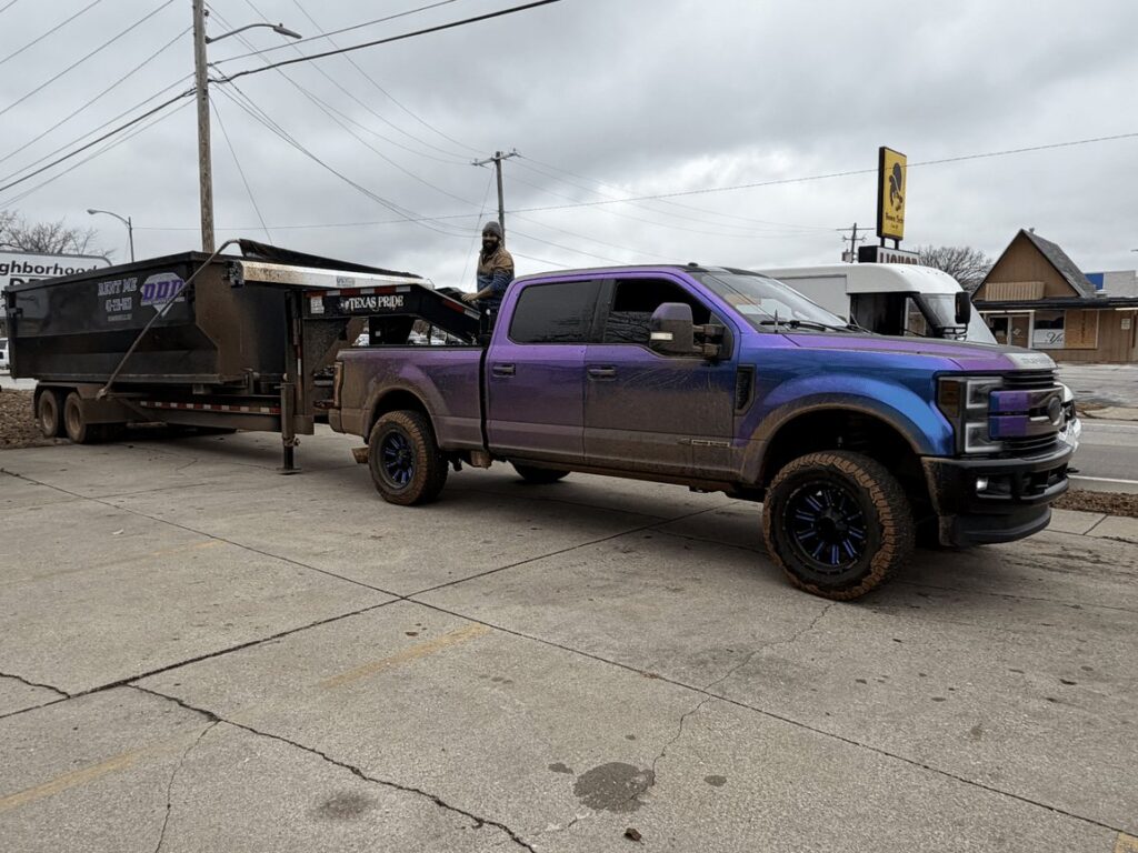Diamond Dumpsters & Dirtworks truck hauling a roll-off dumpster
