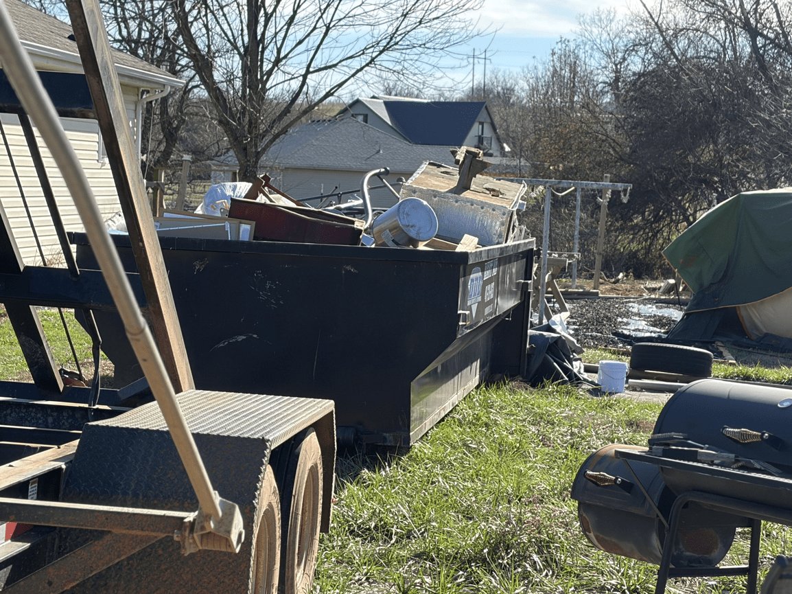 Roll-off dumpster at a residential junk cleanout