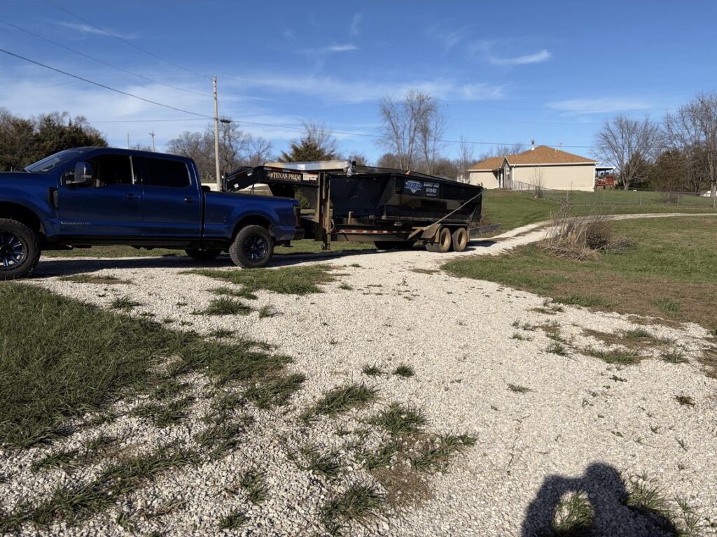 Diamond Dumpsters & Dirtworks truck hauling a roll-off dumpster