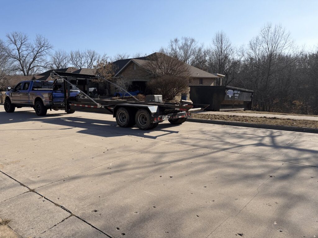 Diamond Dumpsters & Dirtworks truck hauling a roll-off dumpster