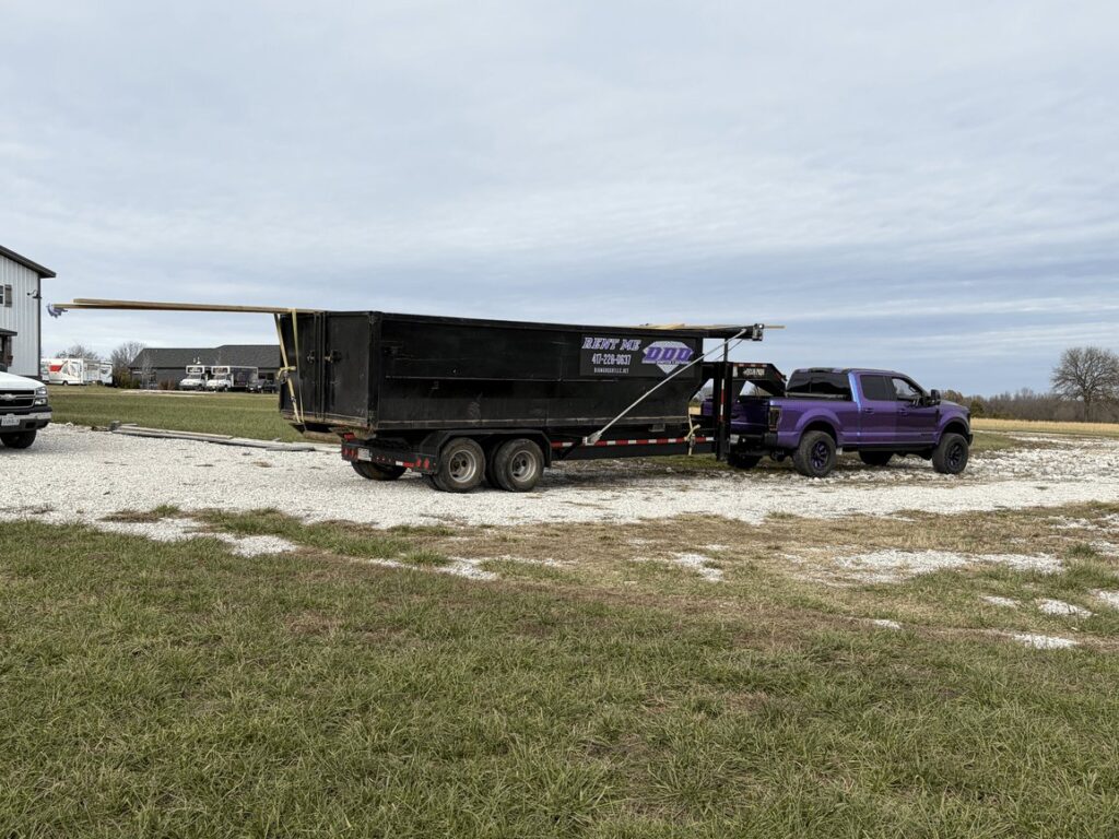 Roll-off dumpster trailer on a job site in the Ozarks
