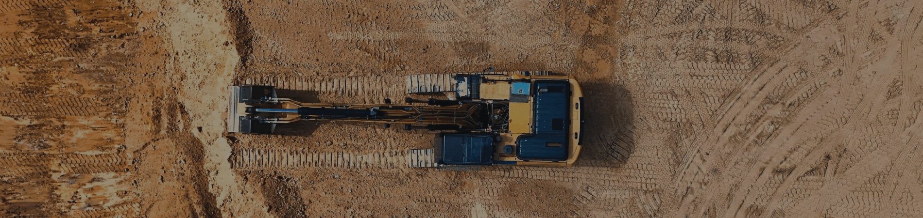 Excavator grading a job site