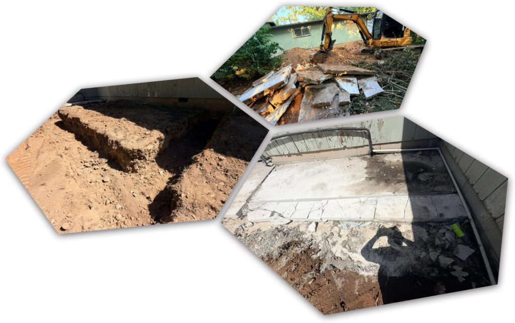 Trench dug along a house foundation, broken concrete being removed by a mini excavator, and a slab area excavated next to a home