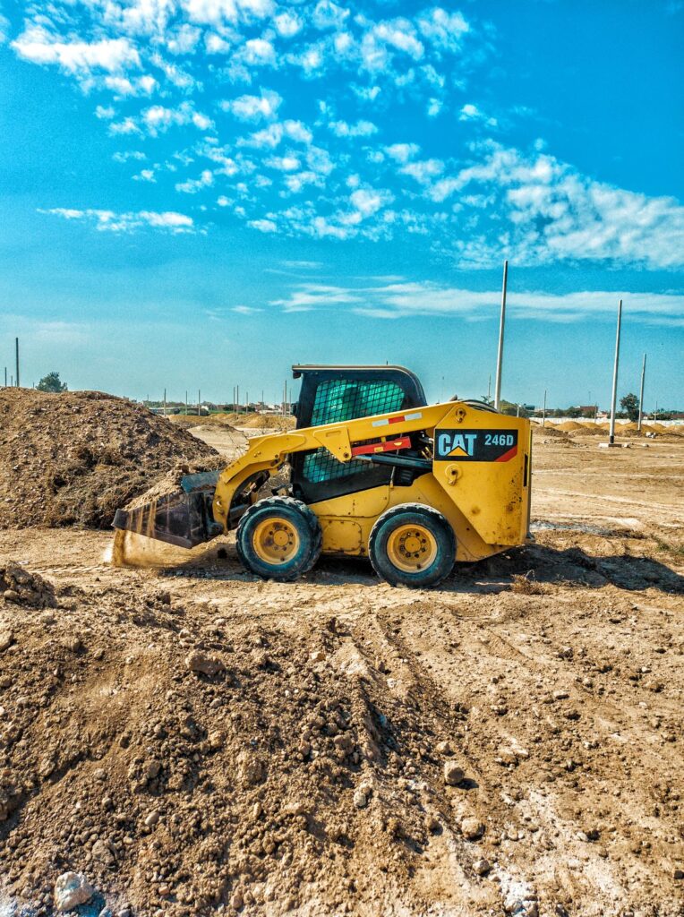 Skid steer grading dirt on a construction site